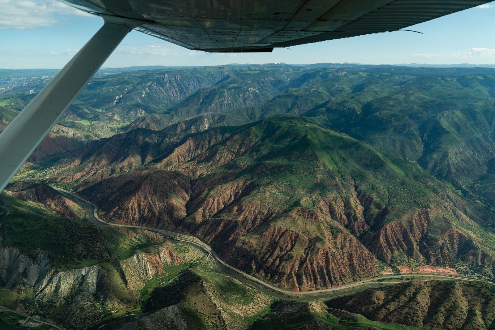 Aerial view of a winding river canyon at golden hour
