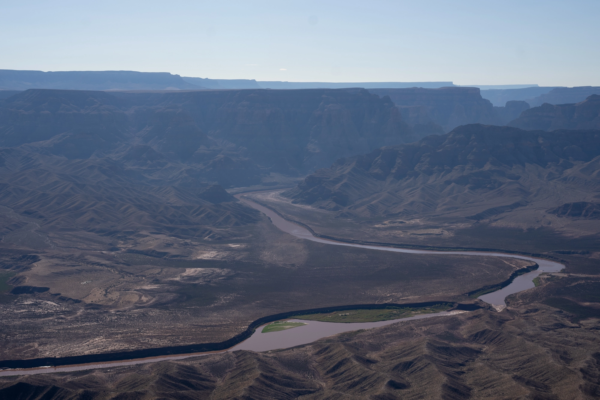 The Colorado River winds through a canyon.