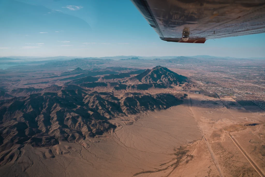 Desert mountains rise above a small city along the Colorado River.