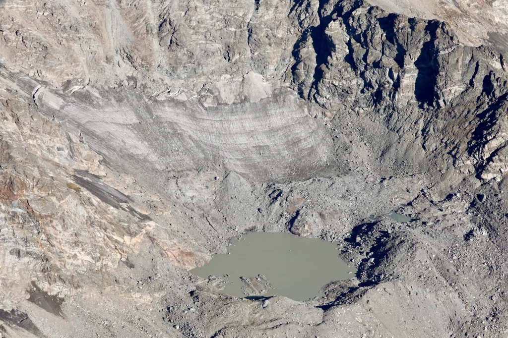 Dirt and rocks covering a small glacier on a Colorado peak.