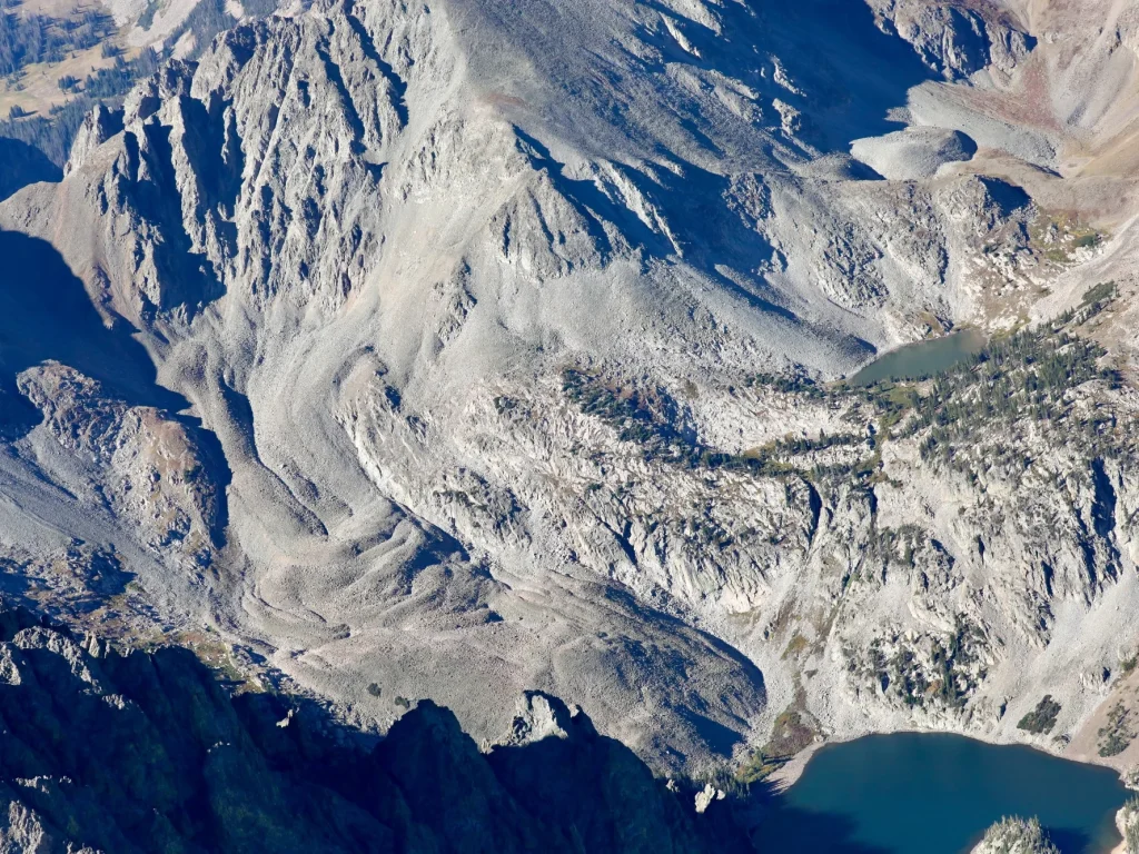 A rock glacier stands out above a mountain lake in Colorado's Rocky Mountains.