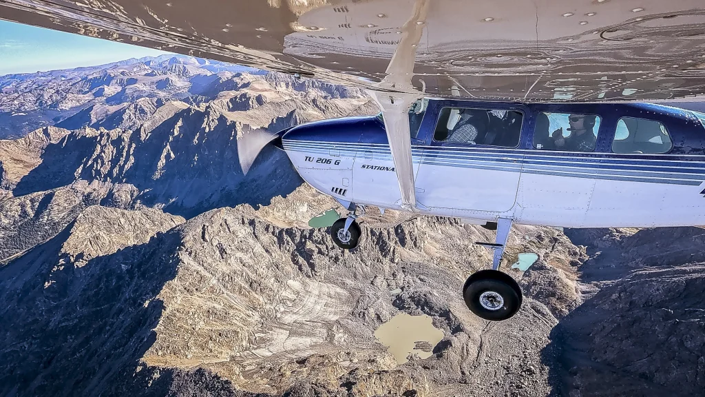 The plane flies above glaciers along Colorado's Continental Divide.
