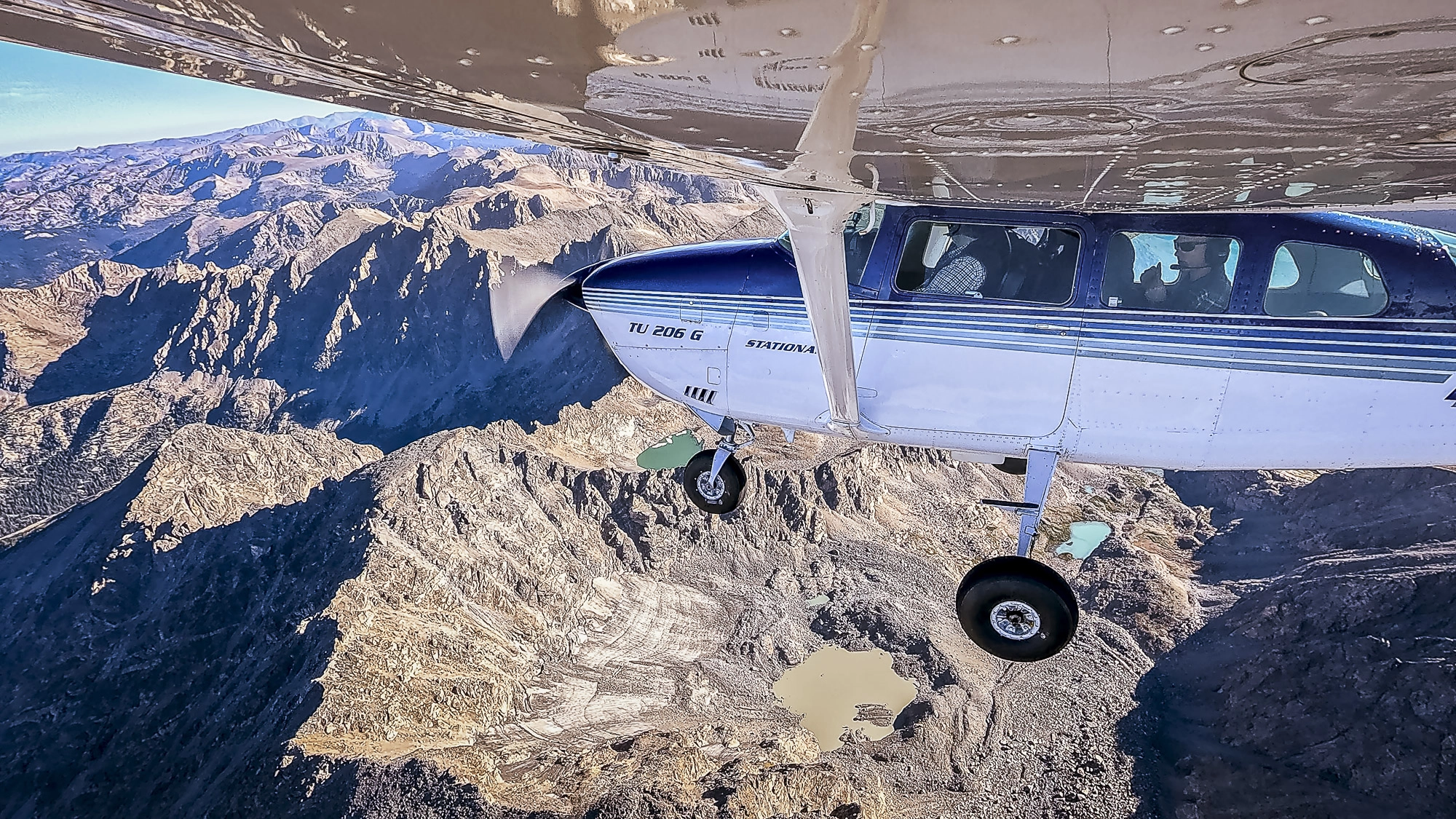 The plane flies above glaciers along Colorado's Continental Divide.
