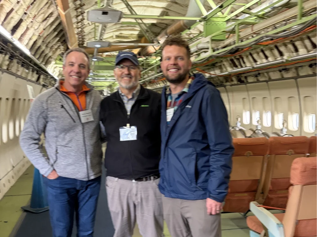 LightHawk board members and RAF pilot in a airline plane exhibit.