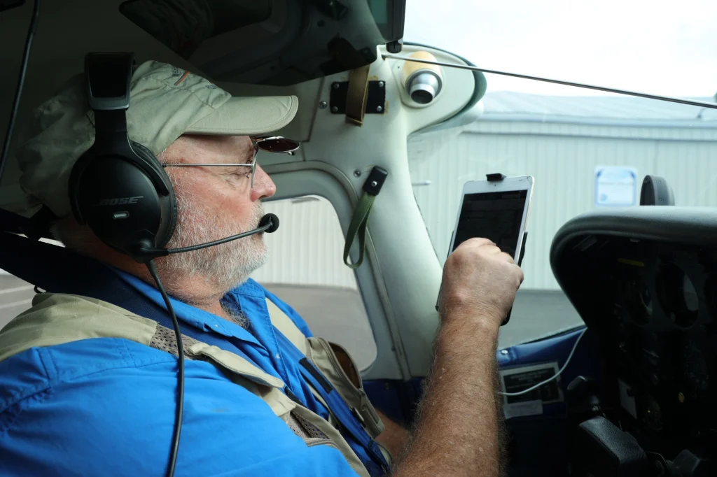 A LightHawk pilot checks his table before a flight.